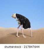 scared ostrich burying its head in sand concept