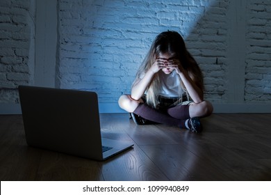 Scared Sad Girl Bullied On Line With Laptop Suffering Cyberbullying And Harassment Feeling Desperate And Intimidated. Child Victim Of Bullying Stalker Social Media Network