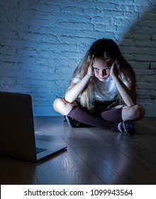 Scared Sad Girl Bullied On Line With Laptop Suffering Cyberbullying And Harassment Feeling Desperate And Intimidated. Child Victim Of Bullying Stalker Social Media Network