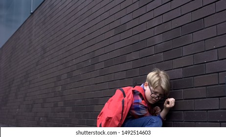 Scared Schoolboy Leaning Against Wall, Hiding From Bullying, Intimidation