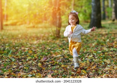 Scared Small Girl Run In Yellow Park Background