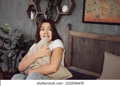 Scared Teen At Home Embracing Pillow  In Living Room At Home