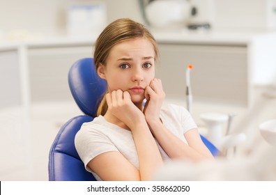 scared and terrified patient girl at dental clinic - Powered by Shutterstock