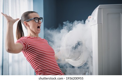 Scared Woman Dealing With A Broken Burning Appliance At Home