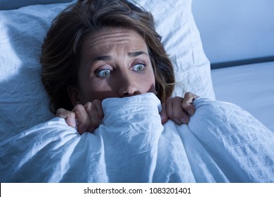 Scared Woman In Her Bed