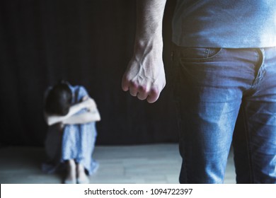 Scared woman protecting from mans aggression. Domestic violence concept