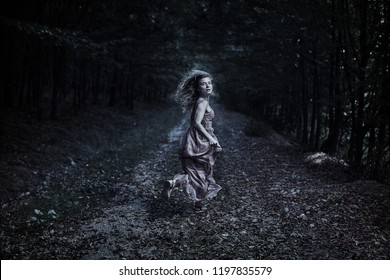 Scared Woman Running Through The Forest