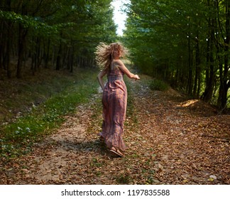 Scared Woman Running Through The Forest