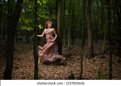 Scared Woman Running Through The Forest