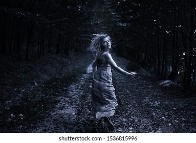 Scared Woman Running Through The Forest