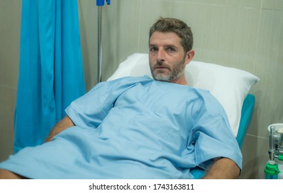 scared and worried man hospitalized - attractive injured man lying on hospital bed receiving treatment feeling sick and unwell after suffering accident or serious disease like cancer - Powered by Shutterstock