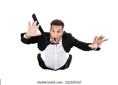 Scared young businessman in falling position. flying businessman on white background and crying