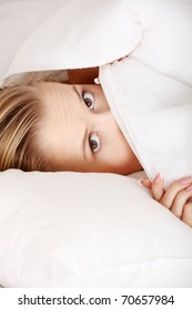 Scared Young Woman In Bed.