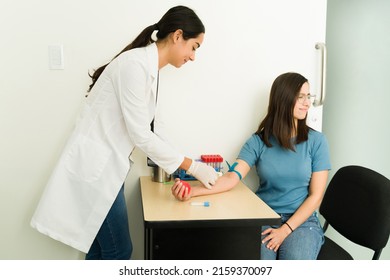 Scared Young Woman Feeling Scared Of Giving Blood At The Medical Laboratory. Technician Drawing Blood At The Lab