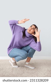 Scared young woman on grey background - Shutterstock ID 2311328209