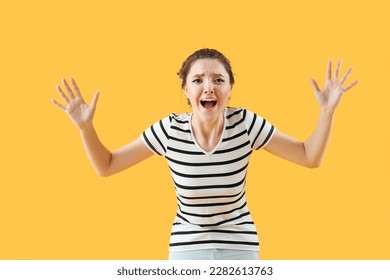 Scared young woman on yellow background - Shutterstock ID 2282613763
