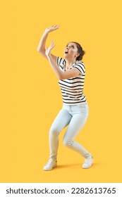 Scared young woman on yellow background - Shutterstock ID 2282613765