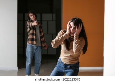 Scared Young Woman Running Away From Crazy Maniac In Room