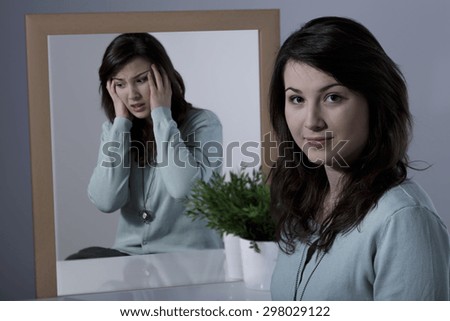 Scared young woman suffering from manic depression 