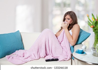 Scared Young Woman Watching TV And Hiding In Blanket