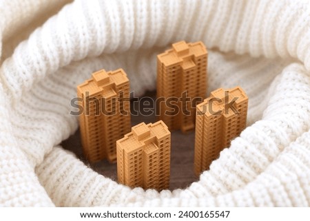 The scarf surrounds the commercial housing model for heating