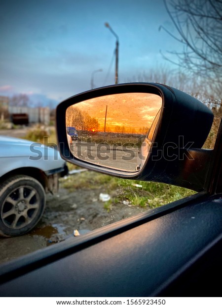 scarlet sunset is\
reflected in the car\
mirror