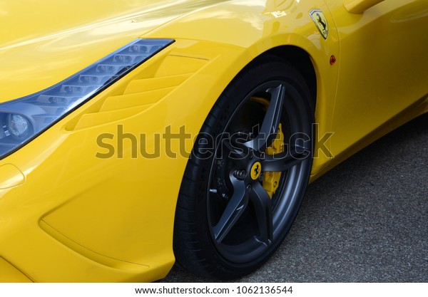 Scarperia\
(Florence), Italy - March 2018 : Detail of a Ferrari sports car in\
the Mugello Paddock. Ferrari S.P.A. is an Italian luxury sports car\
manufacturer, founded by Enzo\
Ferrari.