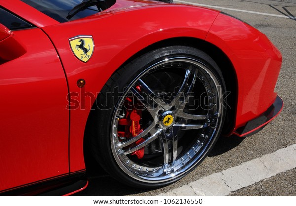Scarperia\
(Florence), Italy - March 2018 : Detail of a Ferrari sports car in\
the Mugello Paddock. Ferrari S.P.A. is an Italian luxury sports car\
manufacturer, founded by Enzo\
Ferrari.