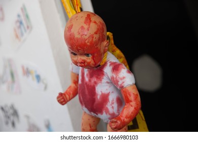 Scary Baby Doll Hanging With Blood In Face And Body. 