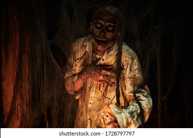 Scary bloodthirsty zombie man in a ruined building. Horror. Halloween.
