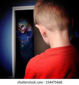 A Scary Clown Is Coming Out Of A Boys Closet In His Bedroom At Night For A Nightmare Or Scary Concept.