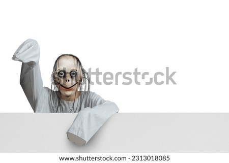 Scary creature standing behind the wall on white background. Scary face for Halloween decoration
