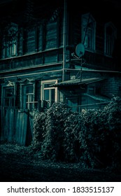 Scary Dark Mysterious Horrible Wooden House With An Attic Windows With A Gate With Creepy Shadows And Strange Light In The Forest, Halloween Horror