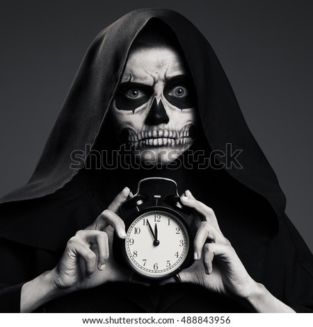 Scary Death Hold A Watch In His Hand. Realistic Skull Makeup.