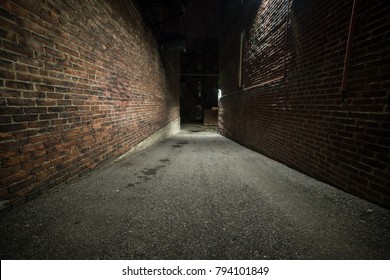 Scary empty dark alley with brick walls