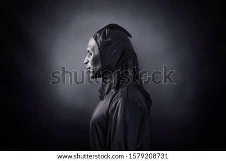  Scary figure in hooded cloak with mask 