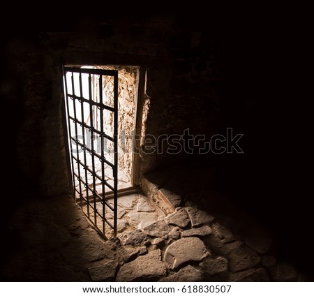 Scary fort cold dirty home iron grate rock brick trap cell wall floor. Gaol gloomy spooky fear shadow walk go rusty hallway way lead release day sky sunlight glow light lit text space backdrop symbol
