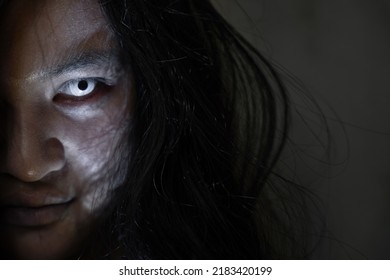 Scary ghost woman. Close up face of Asian woman ghost or zombie horror creepy scary have hair covering the face her eye at abandoned house dark tone, female make up zombie face, Happy Halloween day - Shutterstock ID 2183420199