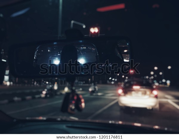 Scary ghost woman in rear view mirror of car,
Halloween Horror scene
background.