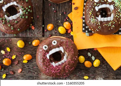 Scary Halloween donuts with chocolate frosting and sugar sprinkles