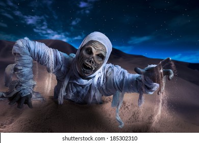 Scary Halloween Mummy In Hot Desert With Dramatic Lighting