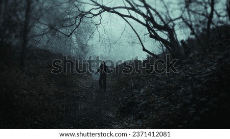 a scary, haunting figure with glowing eyes. Standing in a spooky creepy forest on a moody winters day. With a grunge, vintage edit.