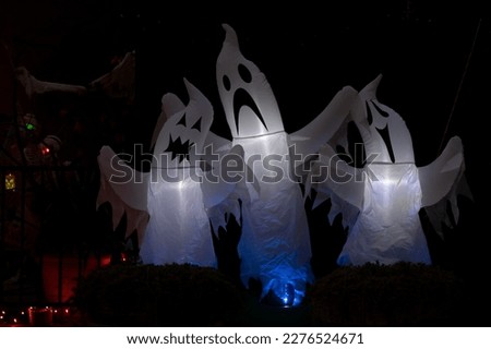Scary inflatable ghosts Halloween deccoration outdoors at night
