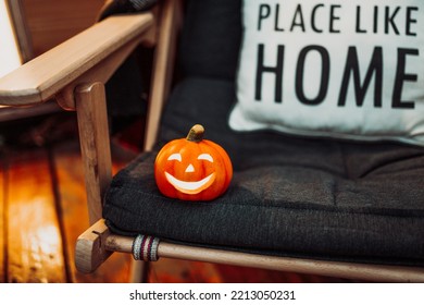 Scary Jack O Lantern Halloween Pumpkins In Sun Day On Ground Among Dry Leaves At Street. Hallows Eve Decoration Funny Glow Pumpkin With Candles On Candlestick At Fall Background In Open Air Near House