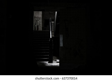 Scary light shinning down a stairwell in an abandoned school - Powered by Shutterstock