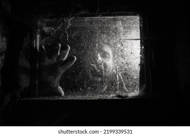 Scary Man Behind Window With Spider Nets At Night Halloween Horror Background