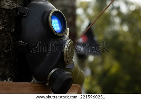 Scary mask. Gas mask with bright eyes. Luminous object. Black gas details.