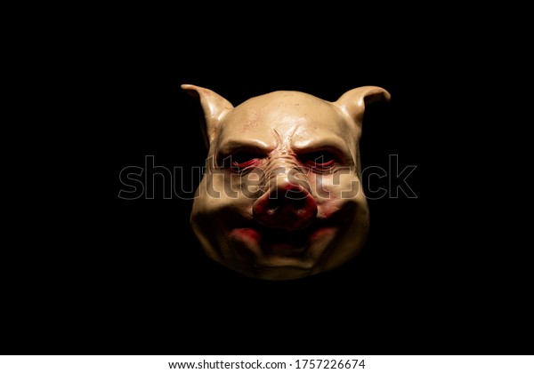 Scary pig mask isolated on black\
background. Bloody horror mask. Halloween\
concept.	