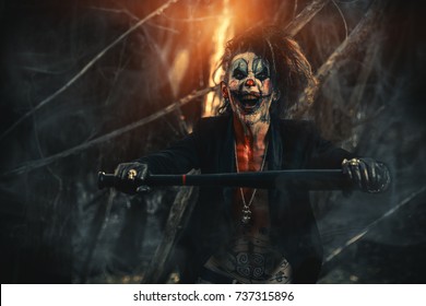Scary Punk Clown Man Smeared With Blood In A Night Forest. Halloween. Horror, Thriller Film.