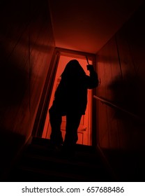 A Scary Robber Shadow Man Is Coming Down The Stairs To A Dark Basement For A Horror, Fear Or Suspense Concept.